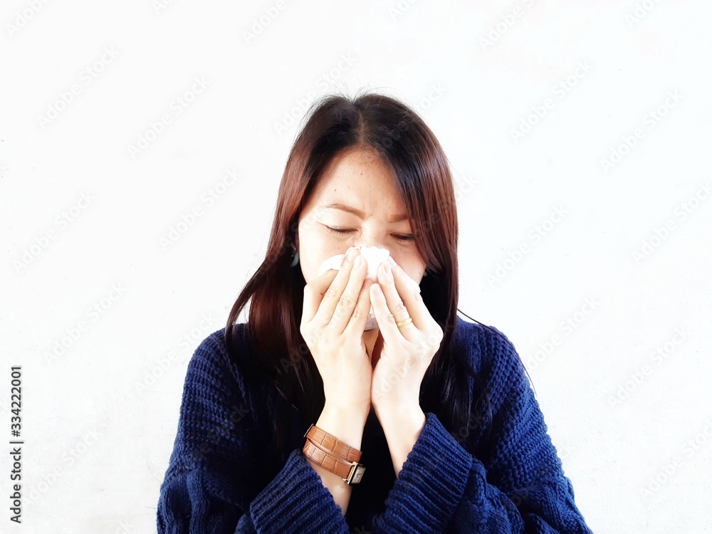 young woman blowing her nose