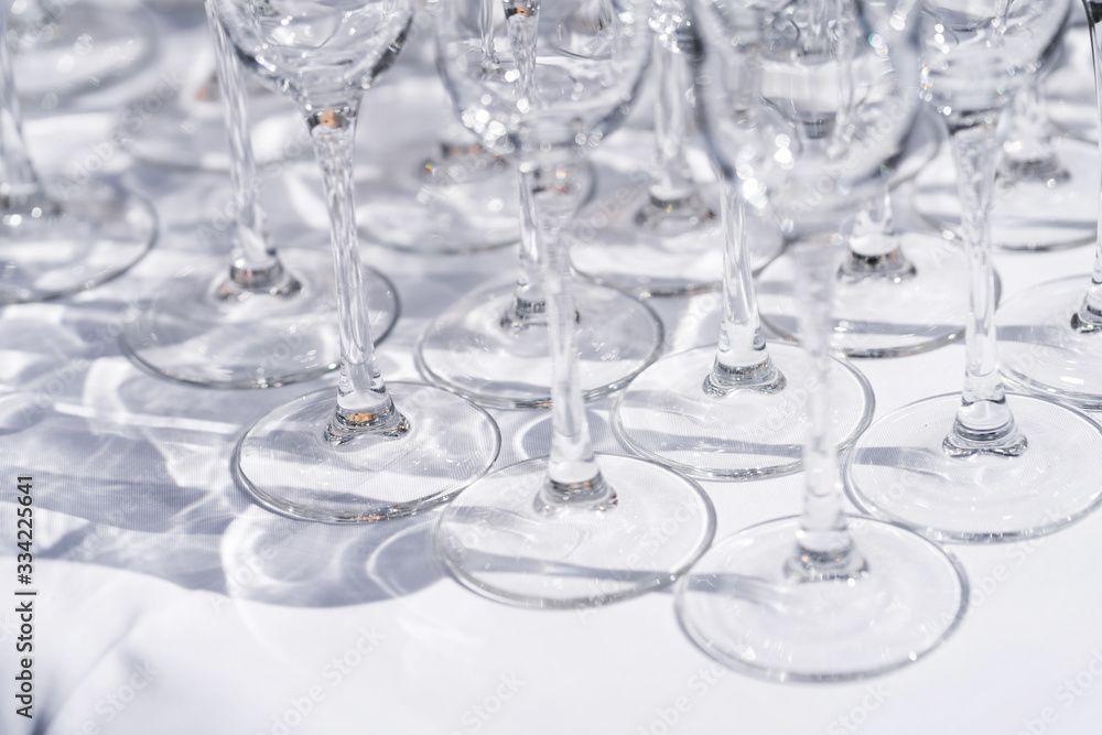 Set of blank empty wine glasses displayed in rows. Preparation for the holiday.