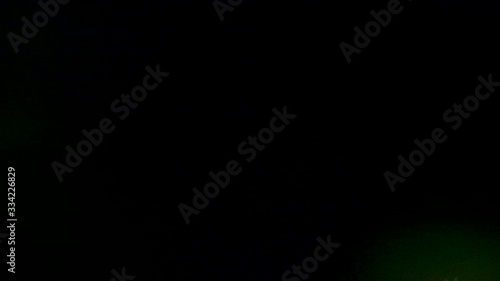 Multicolored light leaks on black background