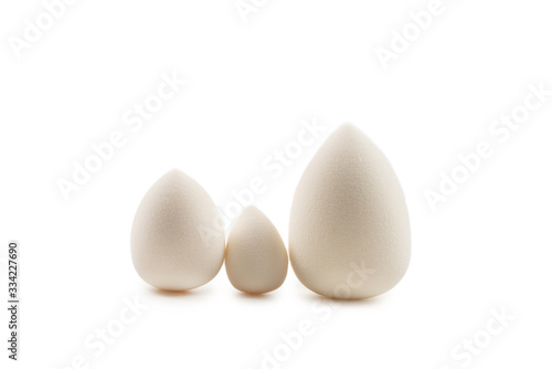 Small, medium and large white beauty blender isolated.