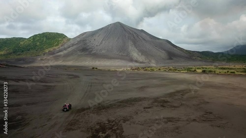 Cinematic Approaching Aerial Yasur Volcano Crater with truck driving Volcano on Tanna Island, Vanuatu photo