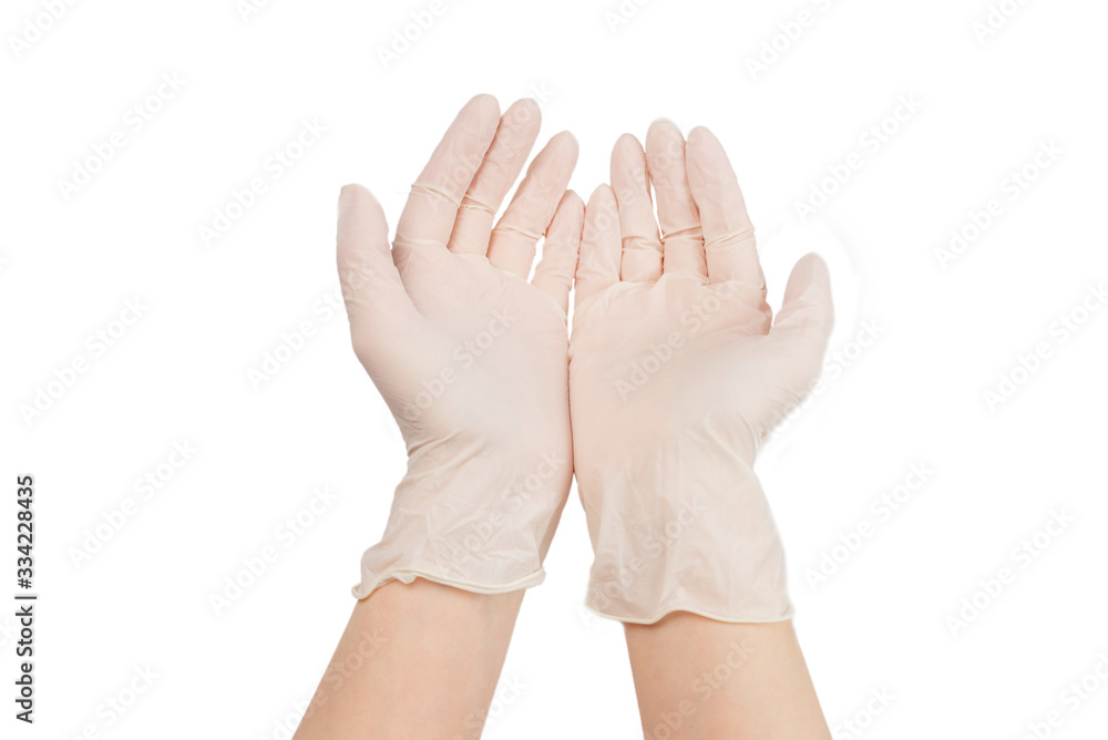 Woman puts on white rubber gloves. Woman puts on white rubber gloves.