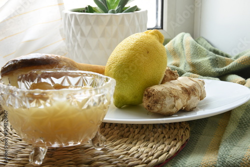 Obraz na plátne Preparing a sweet hot drink with ginger, lemon and honey for easing cold symptom