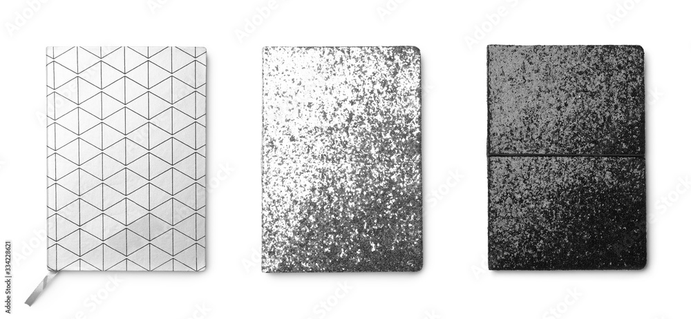 Set of different notebooks on white background, top view