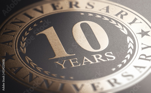 фотографія 10th anniversary, golden stamp over black background