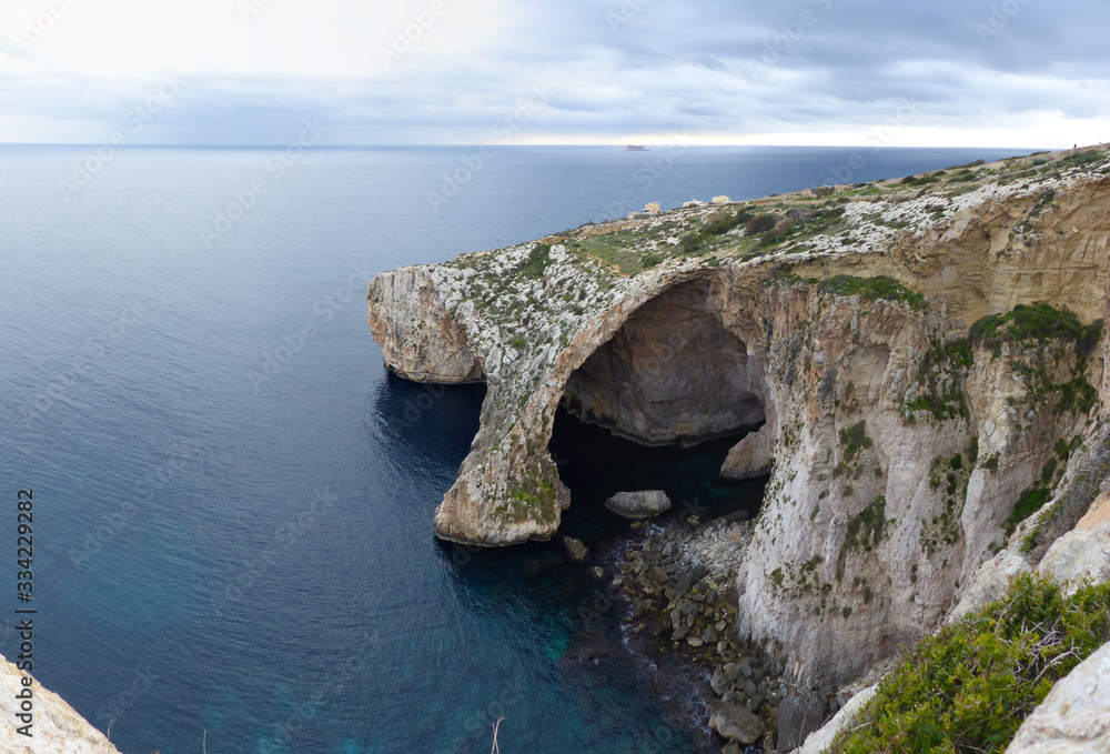 Panoramic view of the cliffs and sea caves of Blue Grotto, Malta.
