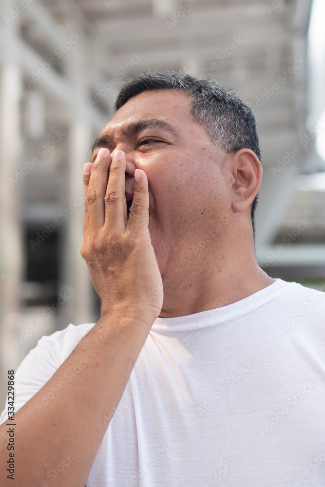 senior old man yawning; tired old uncle yawning from tireness, exhaustion, overwork, insomnia, sleeplessness senior old man yawning; tired old uncle yawning from tireness, exhaustion, overwork, insomnia, sleeplessness