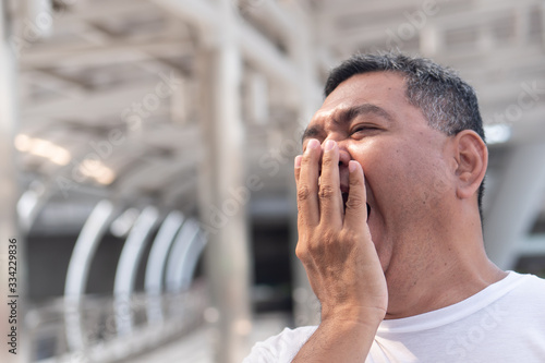 Fotografi senior old man yawning; tired old uncle yawning from tireness, exhaustion, overw