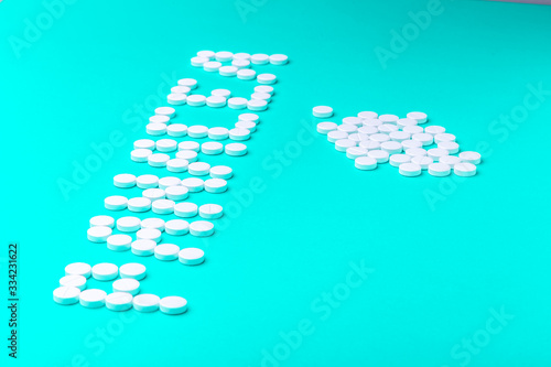 The inscription "Panacea" made of pills on a green background.