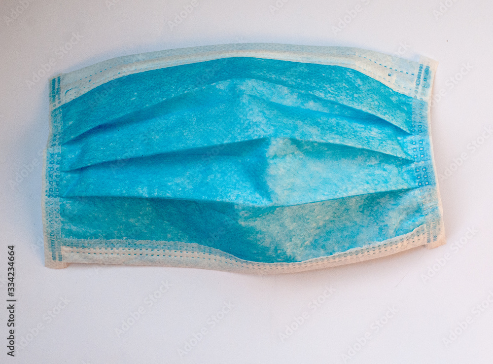 Fototapeta premium Medyczna niebieska maska i na białym tle. Medyczna maska chirurgiczna zapobiegająca koronawirusowi. Koronawirus ochrona.