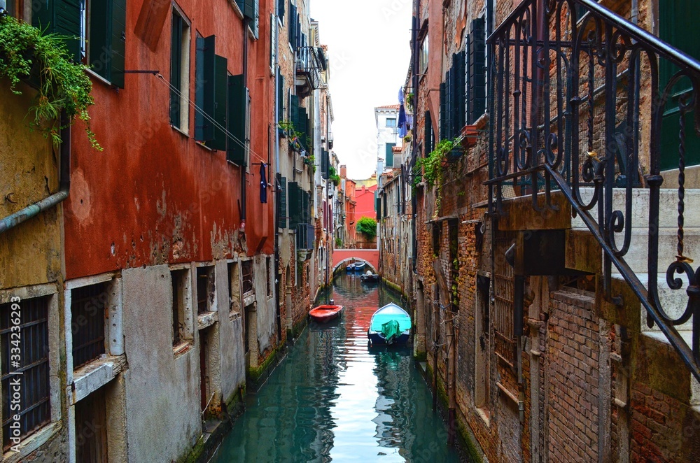 cozy quiet Venetian canal between old houses with rough walls