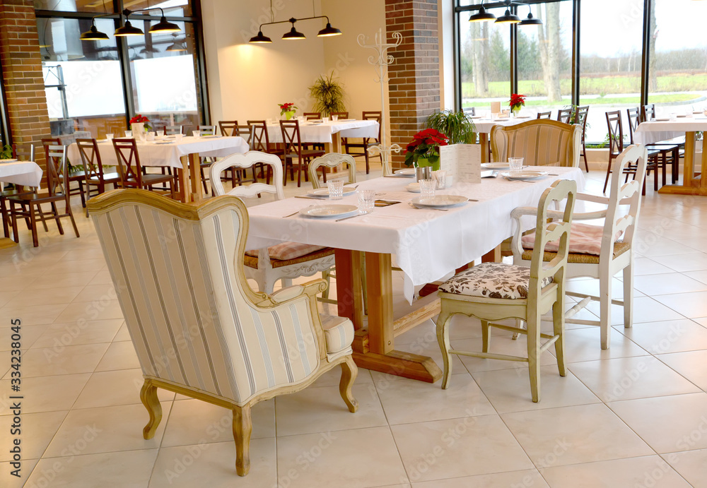 Served table and chairs in the restaurant room. Interior