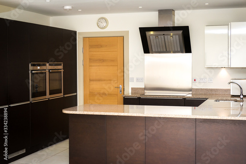Nice high standard kitchen with dark furniture, in the English style