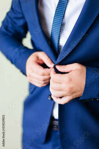 groom in white shirt with blue tie and blue jacket. groom's meet