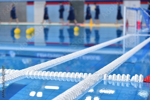 Foto Swimming pool lane lines and floating on a still water with polo balls in backgr
