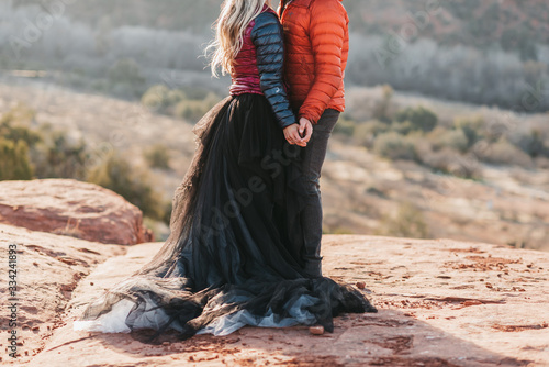 couple holding hands during adventure desert elopement photo