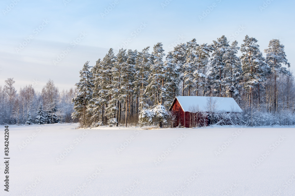 Old barn in snowy landscpe, Finland