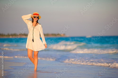 Young beautiful woman in sunset background of ocean