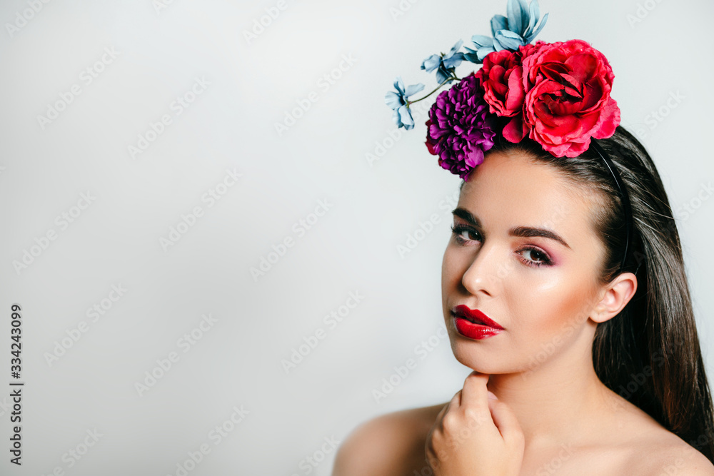 Pretty spring girl with flowers on her head and bright makeup. May calendar beautiful girl.