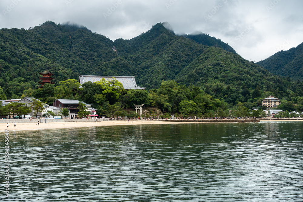 View of Miyajima island (Itsukushima) a popular destination from Hiroshima for its shrines and the big torii gates floating on the water, Japan