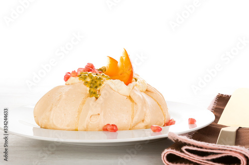 Gourmet Pavlova dessert with passion fruit and pomegranate.