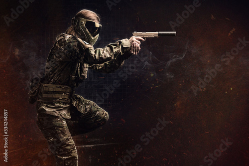 Paintball. Female recon fighter. Background. photo