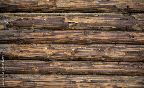 Photographie Wooden background. Old wooden wall of a rustic house with texture