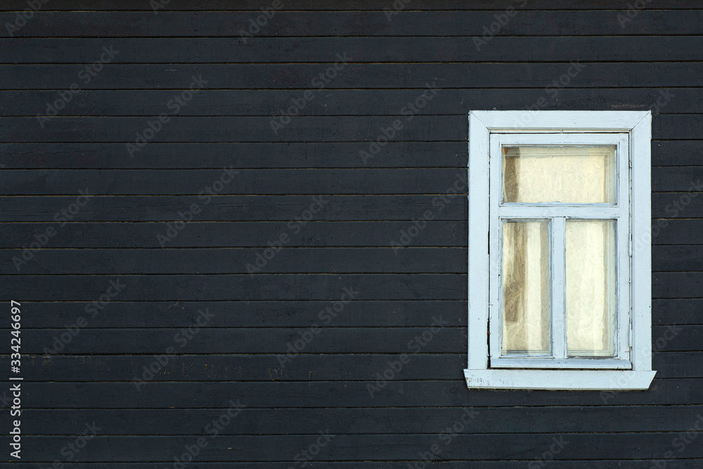 Fototapeta premium Scandinavian house. Dark wooden wall of the facade of a scandinavian house with a window. Copy space