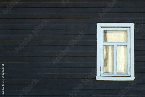 Scandinavian house. Dark wooden wall of the facade of a scandinavian house with a window. Copy space