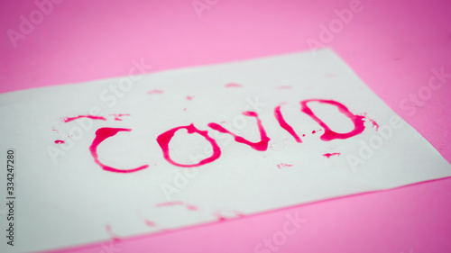 Red letters COVID19 written on white paper