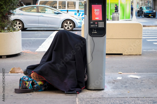 Homeless person stays plugged into charging station. NYC Covid 19 pandemic