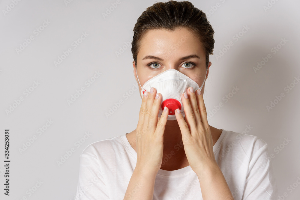 Young woman is wearing a face mask for protection against virus Young woman is wearing a face mask for protection against virus