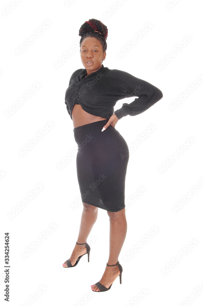 Fototapeta premium Young African woman standing in profile in gray dress