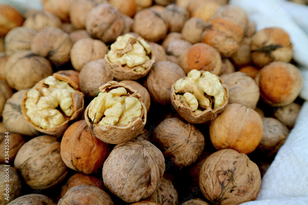 Closeup Raw Walnut's Kernels on the Pile of Walnuts with Shells Closeup Raw Walnut's Kernels on the Pile of Walnuts with Shells