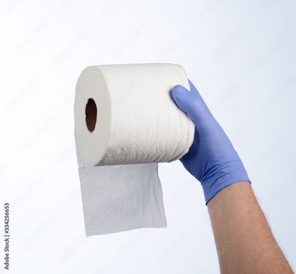 Obraz premium Right hand in blue glove holding a roll of toilet paper