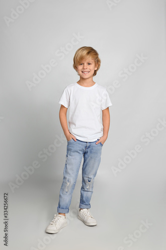 Canvas-taulu Cute little boy in casual outfit on light grey background