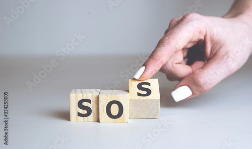 SOS word collected of wooden elements with the letters. SOS help concept.