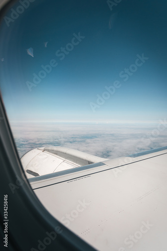 Wing of an airplane during a flight against a blue sky © LALSSTOCK