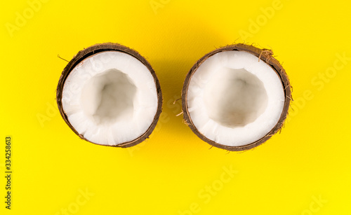 .two half coconut on a yellow background