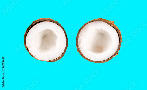 two halves coconut on blue background