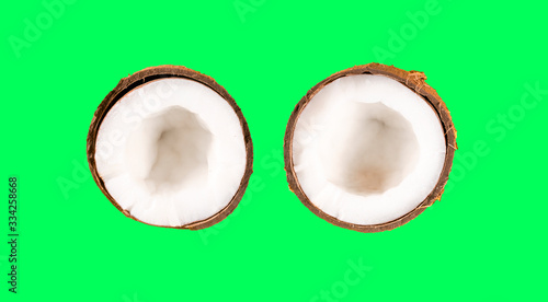 two halves coconut on green background