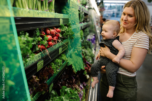 mother and daughter grocery shopping for organic vegetables