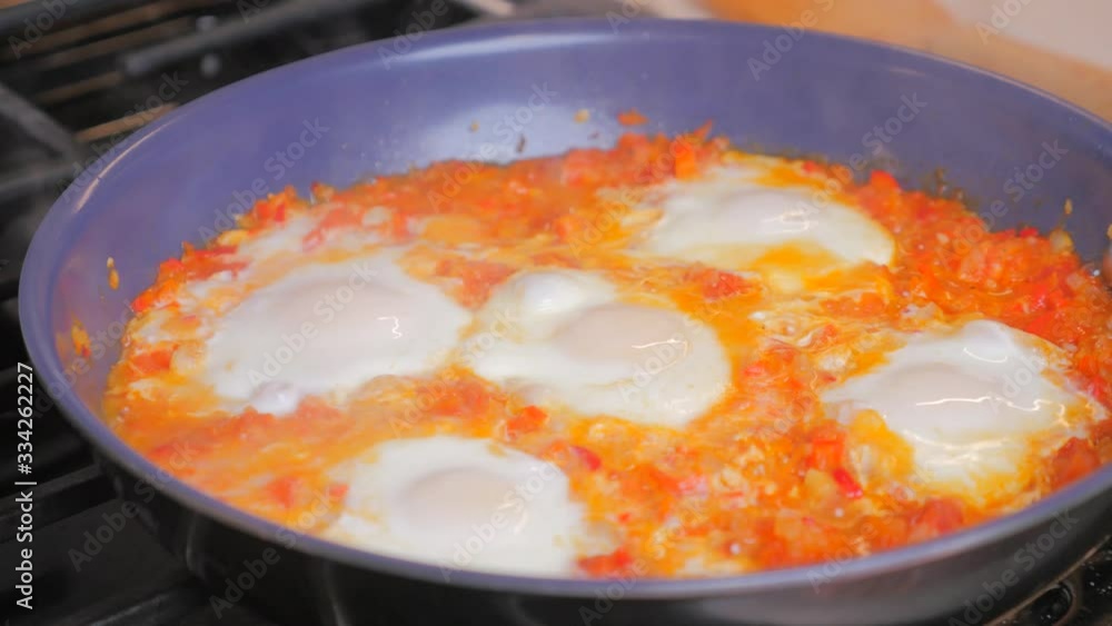 Shakshuka, Fried Eggs in Tomato Sauce for Easter Brunch. Tasty and Healthy Eggs in a Frying Pan. Eggs Poached in Spicy Vegetable Sauce. Mediterranean vegetarian cuisine breakfast.