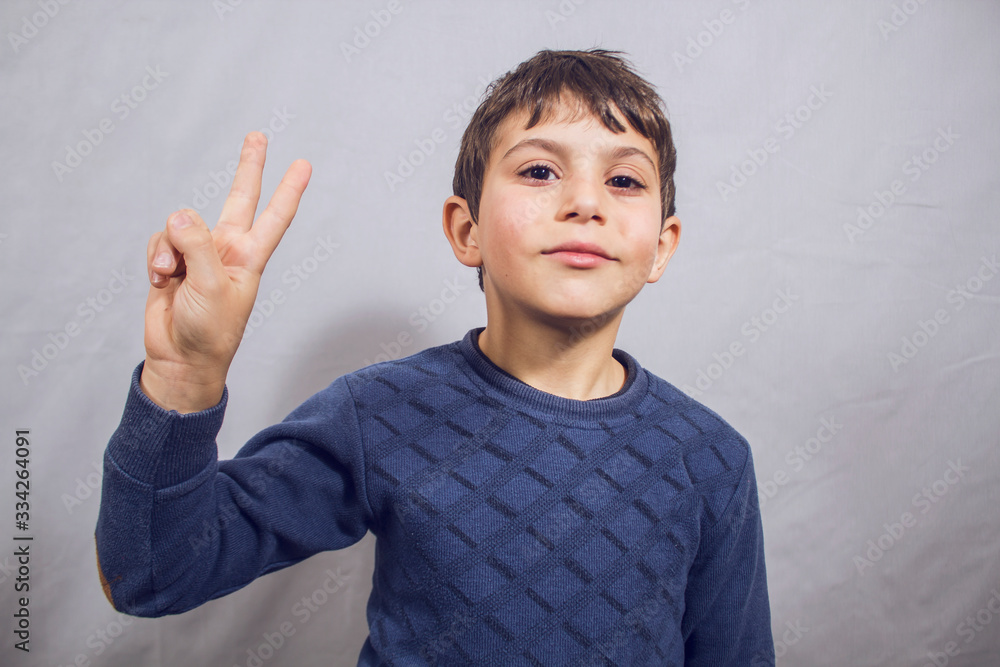 boy shows peace sign with fingers boy shows peace sign with fingers