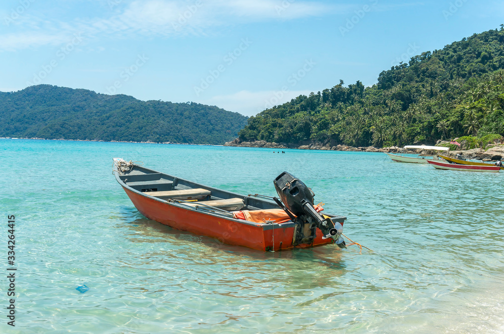 Boats with clear water and blue skies at Perhentian Island, Malaysia