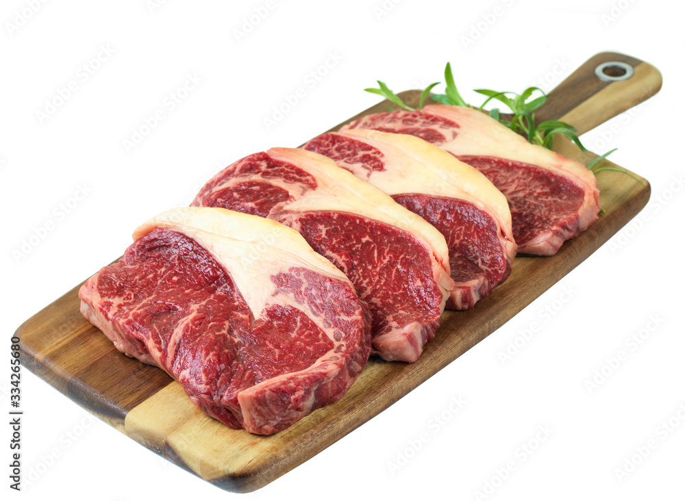 raw meat on a cutting board isolated on white
