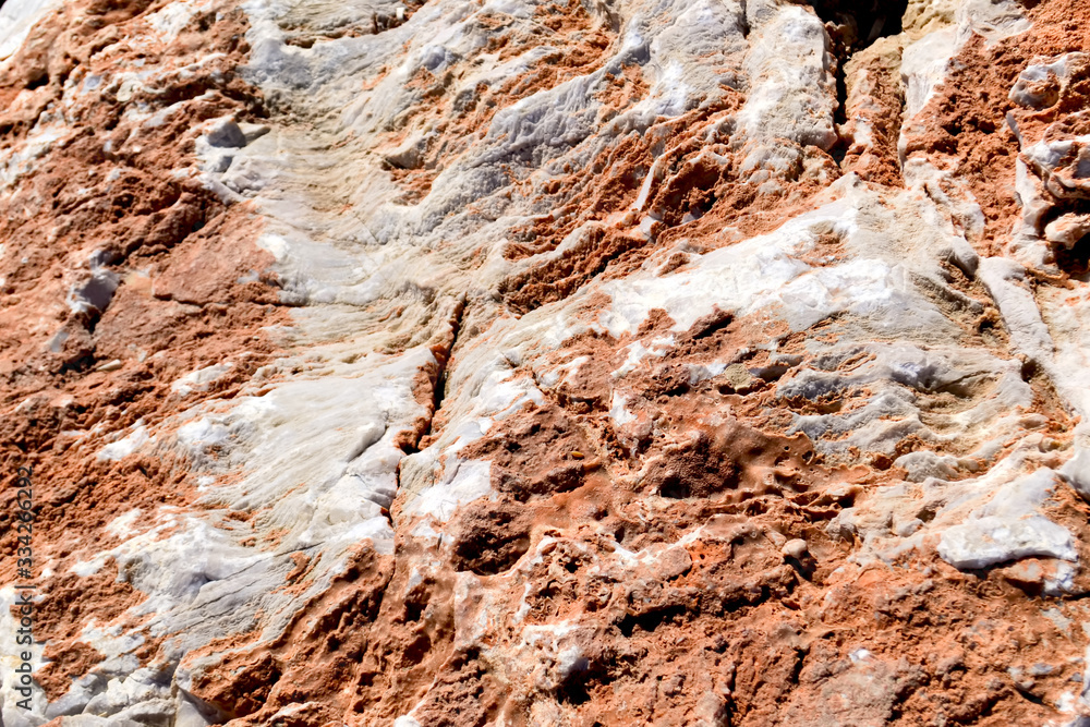 Obraz premium Rough untreated stone surface of marble beige color texture with clay