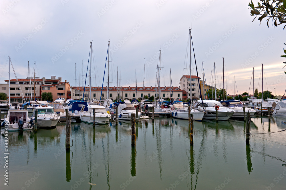 Boats waiting in the port of Caorle, a charming holiday resort and fishing village.Italy.