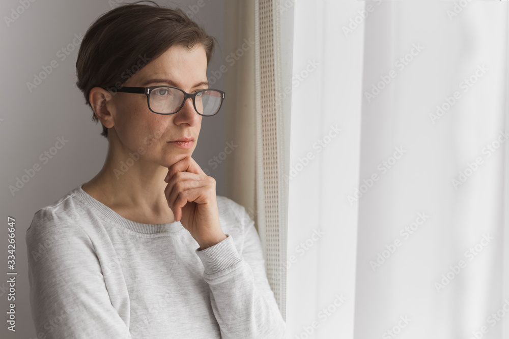Portrait of a pensive young woman near the window. Portrait of a pensive young woman near the window.