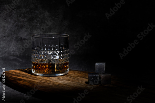  Glass of whisky on concreete background photo